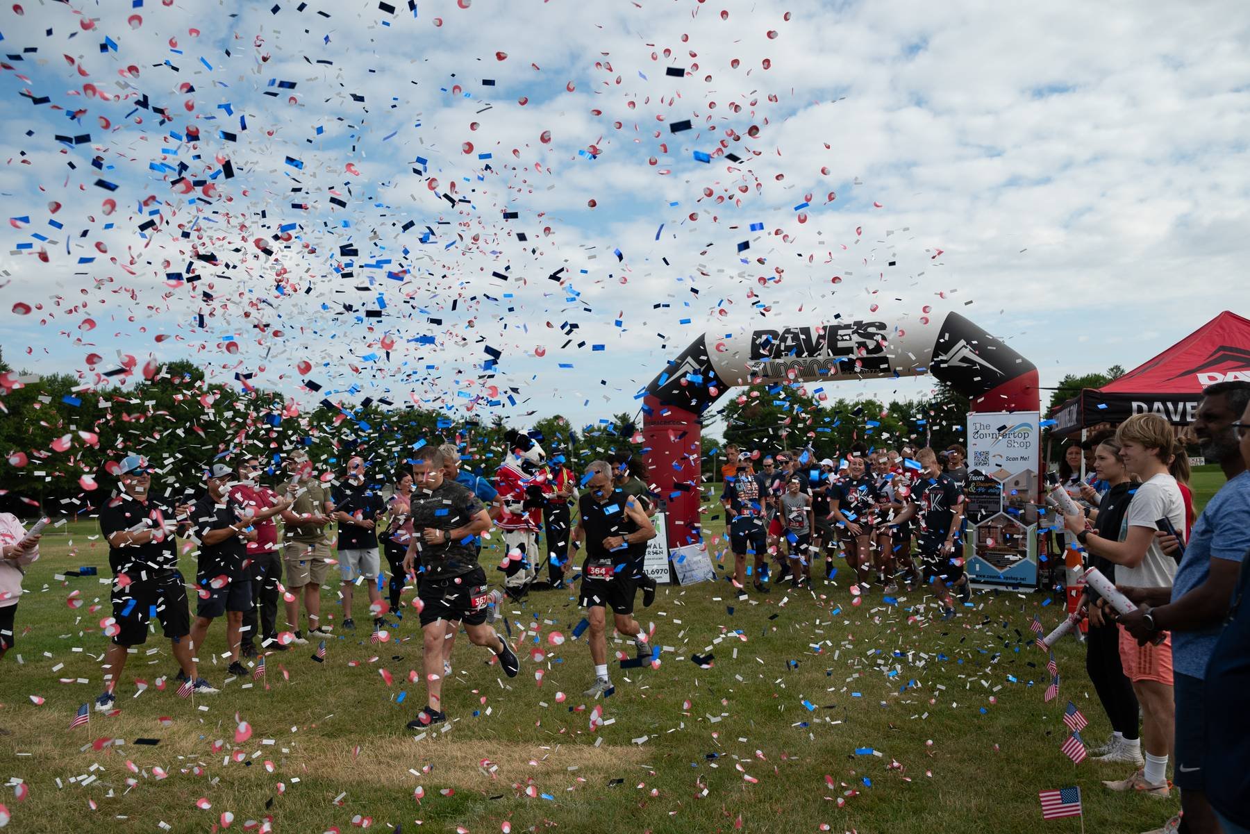 Runners crossing the finish line at a Northwest Ohio community 5k